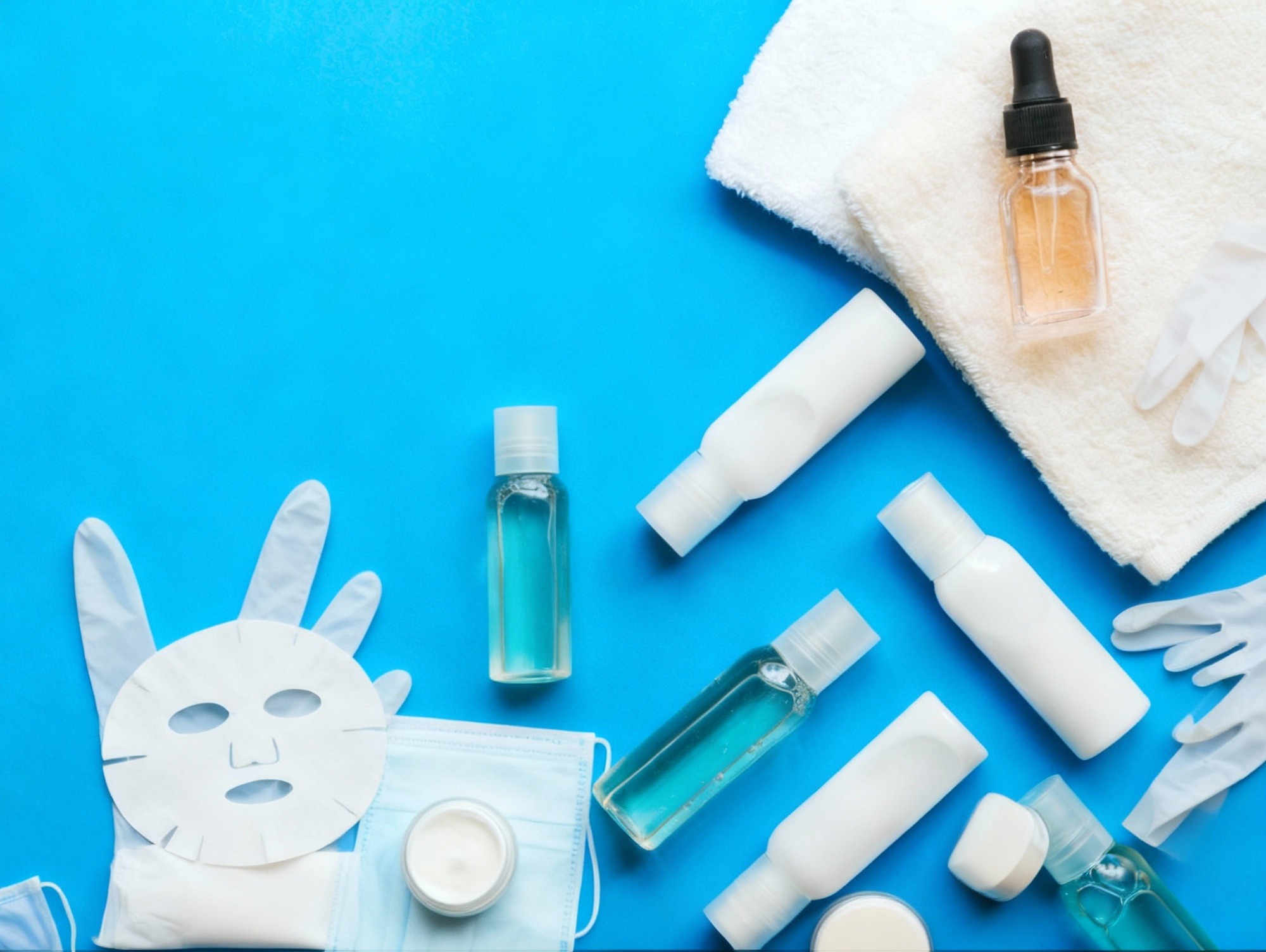 Flat lay of professional-grade chemical peel acids, gloves, and post-care skincare products.