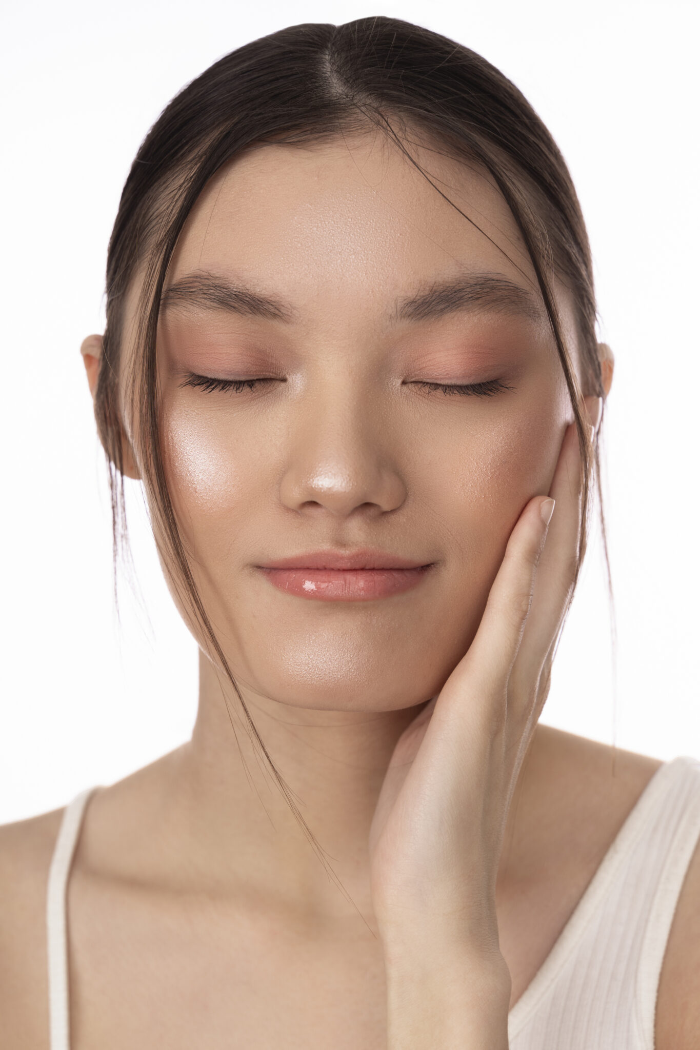 Close-up of a woman’s radiant, makeup-free face with glowing, healthy skin after a facial.