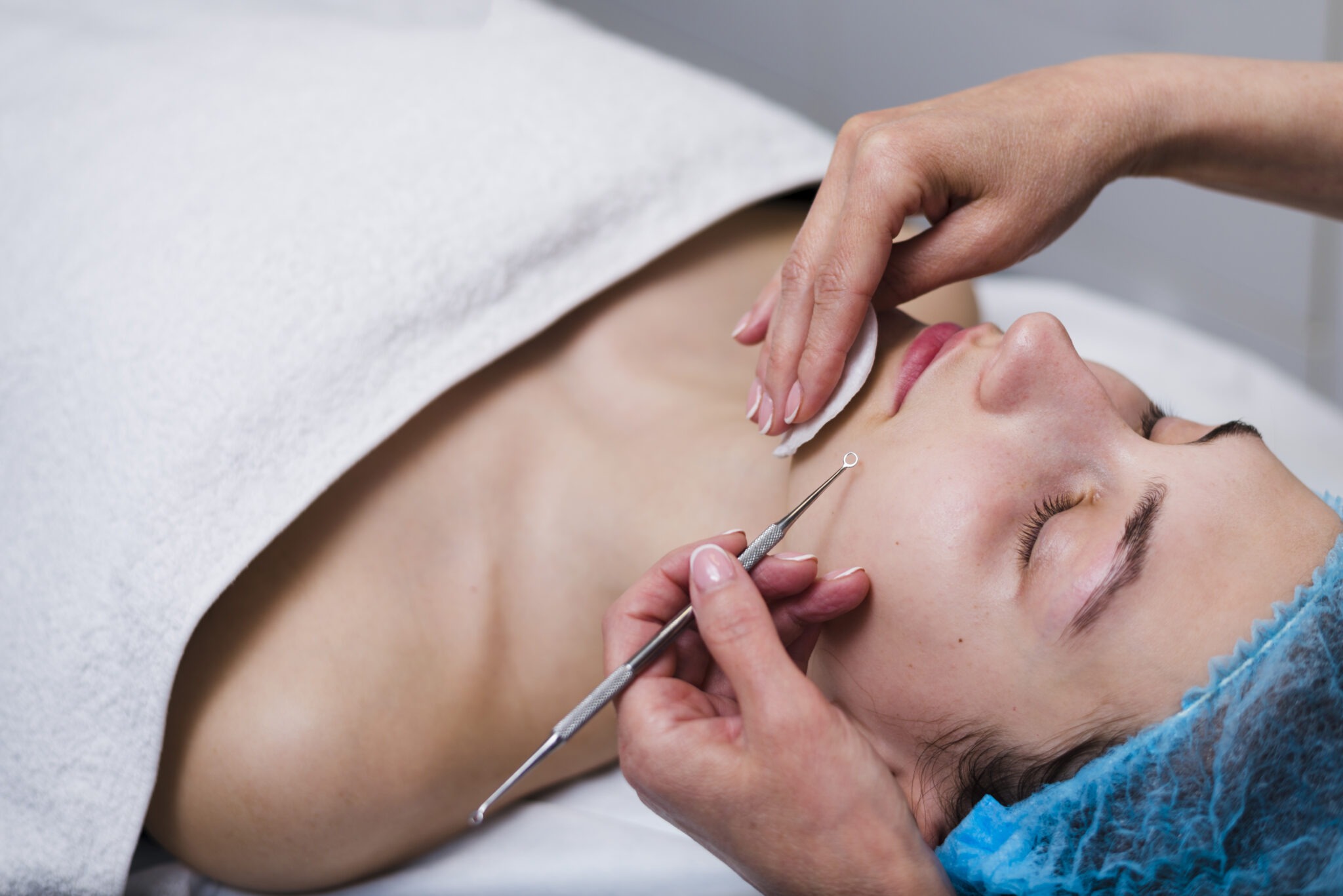Esthetician performing dermaplaning as part of a custom facial