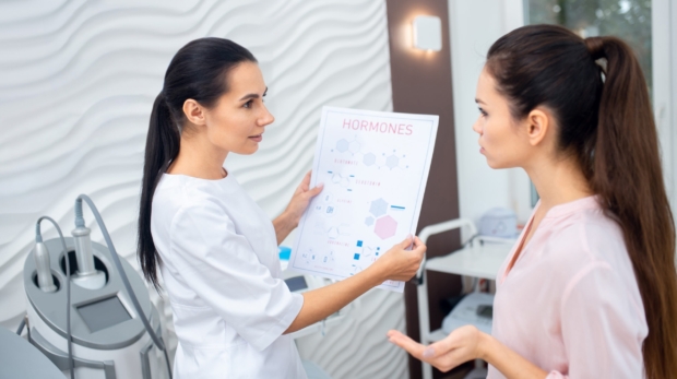 Esthetician consulting a client before a customized facial