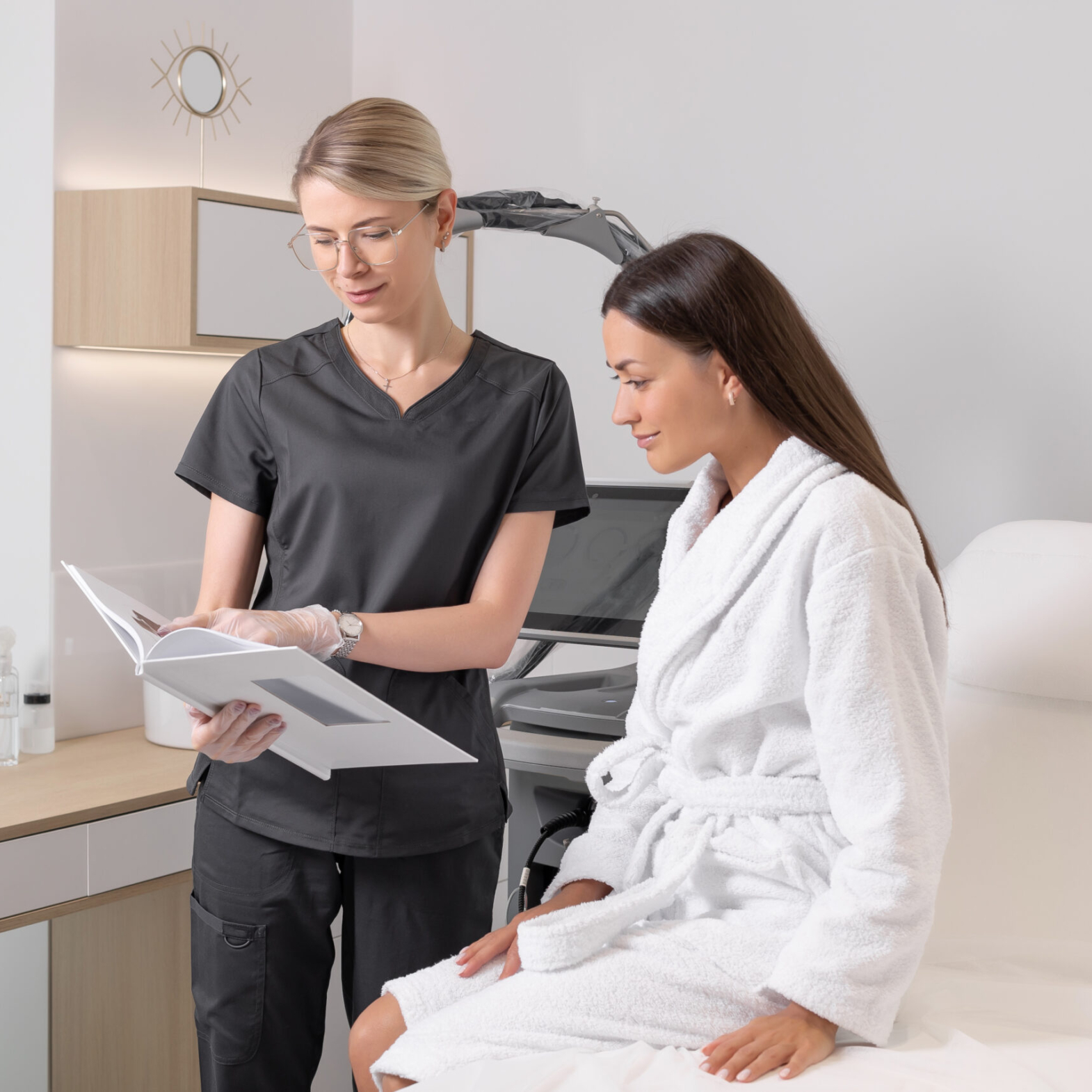 An aesthetician consulting a patient for scalp aesthetics and hair rejuvenation at Reveal Clinics Riyadh.