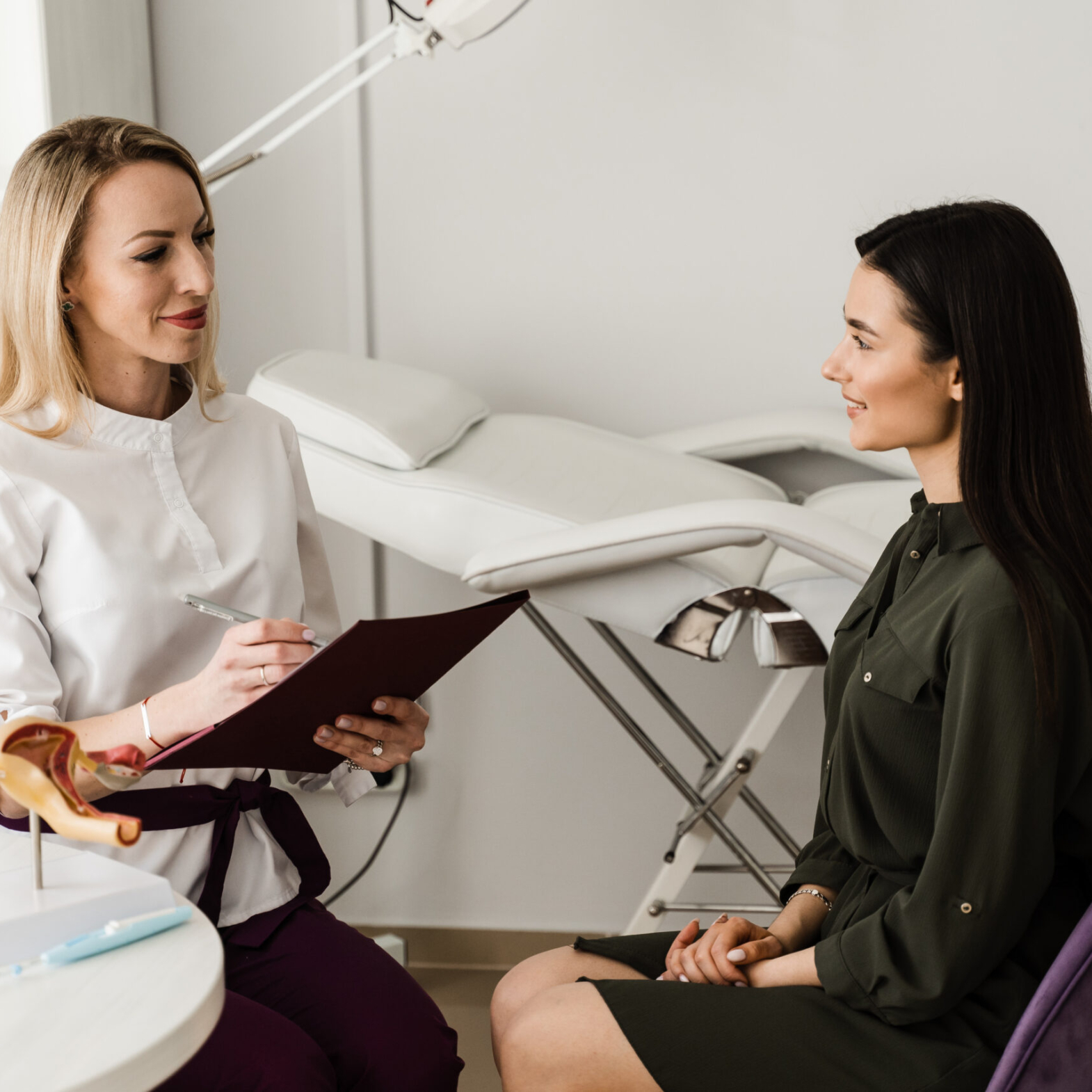 An Aesthetician consulting a patient for non-surgical facial contouring at Reveal Clinics Riyadh.