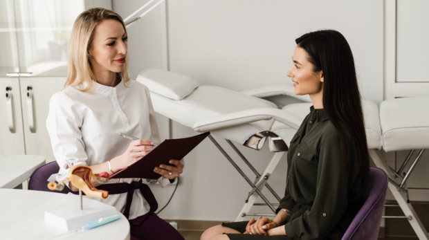 An Aesthetician consulting a patient for non-surgical facial contouring at Reveal Clinics Riyadh.