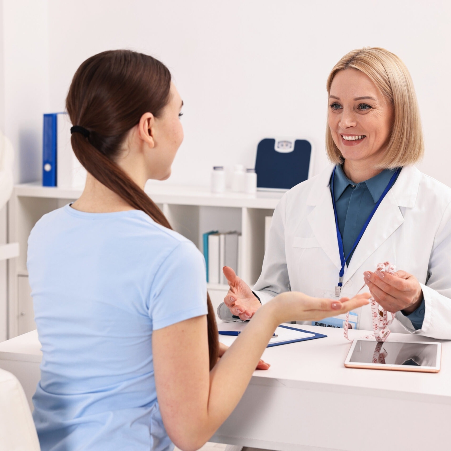 An aesthetician consulting a patient for Exosome Therapy and Cellular Beauty treatment at Reveal Clinics Riyadh.