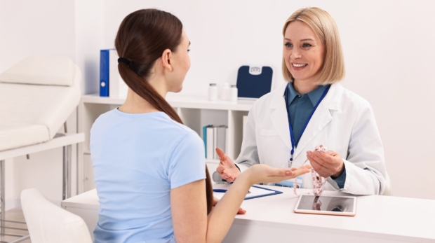 An aesthetician consulting a patient for Exosome Therapy and Cellular Beauty treatment at Reveal Clinics Riyadh.