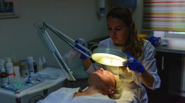 Close-up of a brightening laser session (generic PicoWay or Fraxel handpiece).