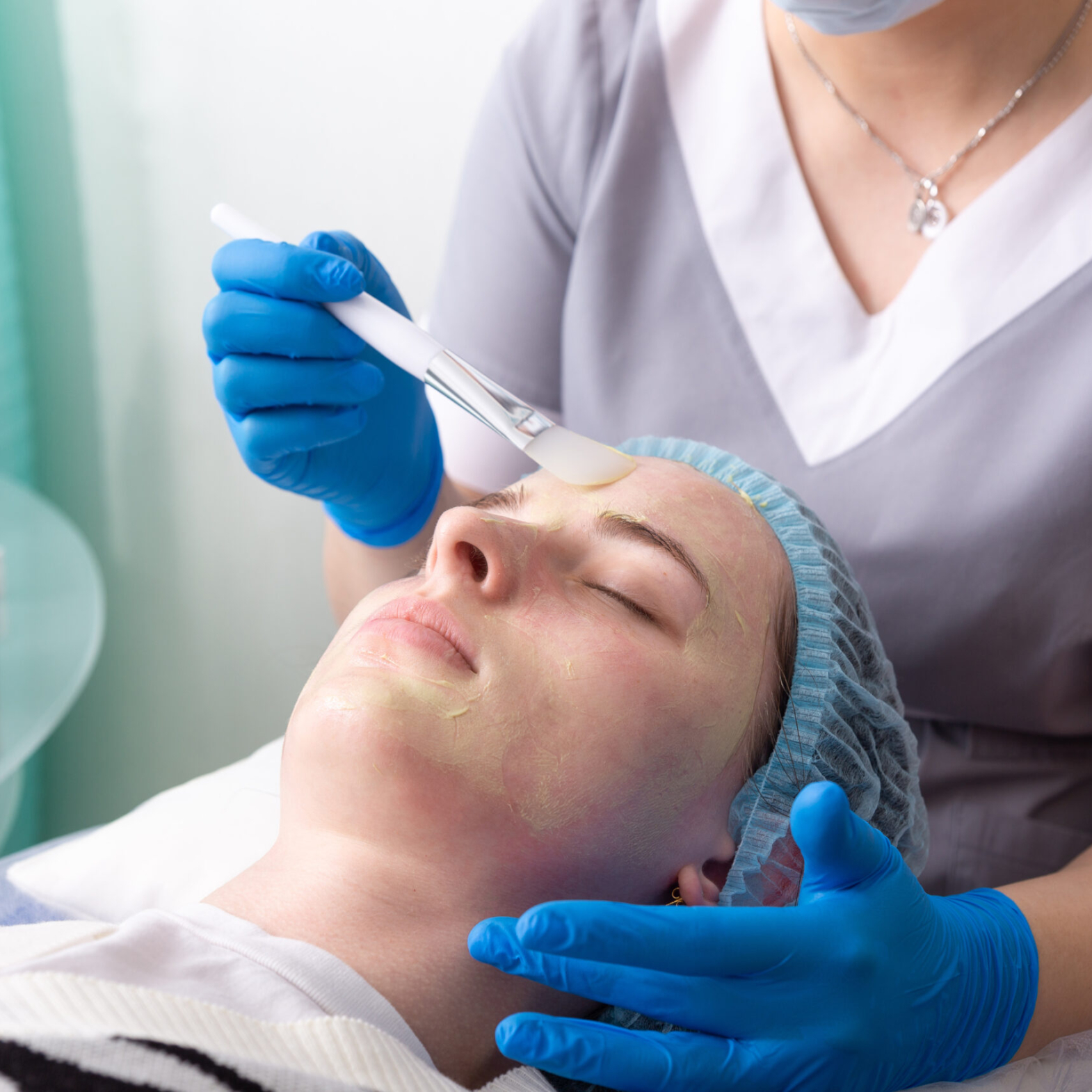 Dermatologist performing customized chemical peel treatment