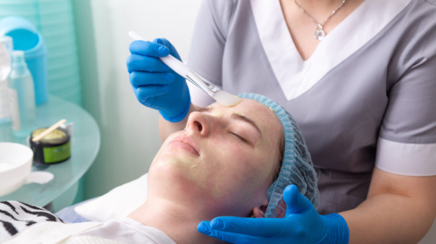 Dermatologist performing customized chemical peel treatment