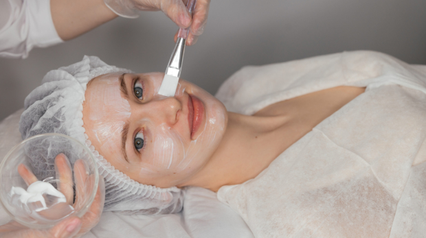 Woman receiving chemical peel in a dermatology clinic during winter