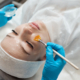 Dermatologist applying advanced chemical peel treatment on face